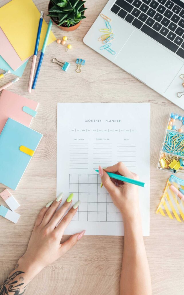 Woman's hand writing with colorful stationery